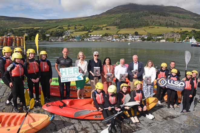 Participants in the Teen Girls Sea Kayaking programme at Carlingford Adventure Centre pictured with; Mary Van Lieshout, Sport Ireland; Joanna Kelly, Louth County Council; Cllr Dolores Minogue, Cathaoirleach of Louth County Council; Graham Russell, Louth Local Sports Partnership; David Conway, Chief Executive of Louth County Council; and Paula Keenan, Louth County Council; at the launch of the Louth Local Sports and Physical Activity Plan 2026-2031 during HER Outdoors Week.