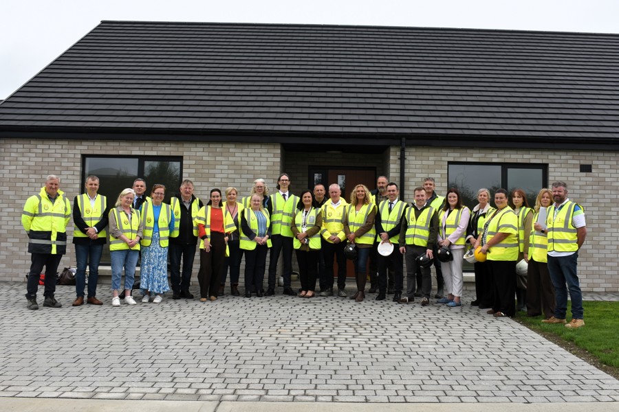 Louth County Council elected members, officials, and guests during a visit to An Mullach, Louth County Council's new social housing development in Louth Village.